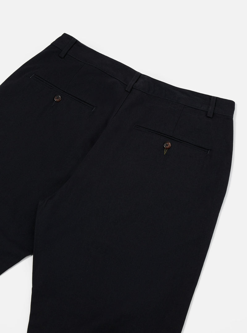 Detailed close-up view of the Black Twill Military Chino trousers on a plain background. Shows the durable black twill fabric weave, waist button detail, and precise stitching along the pocket seam.