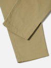 Close-up of the Sand Twill Military Chino, showcasing the fabric's texture and color. The pants are laid on a white surface, highlighting their fit and material.