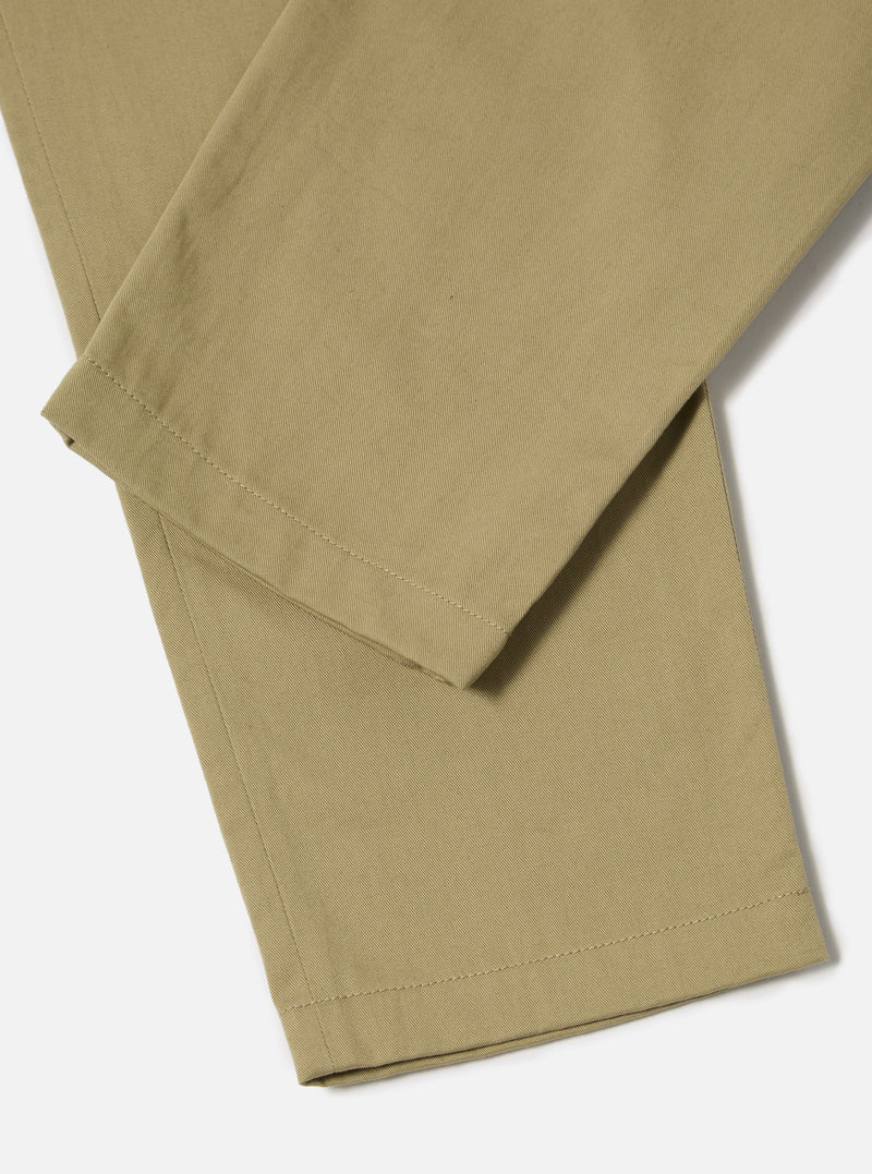 Close-up of the Sand Twill Curved Pant on a white background. The sand-colored twill fabric shows a subtle texture and clean lines.