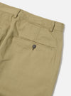 Close-up of the sand twill military chino, showcasing the fabric texture and button detail. The garment is laid on a clean, white surface.