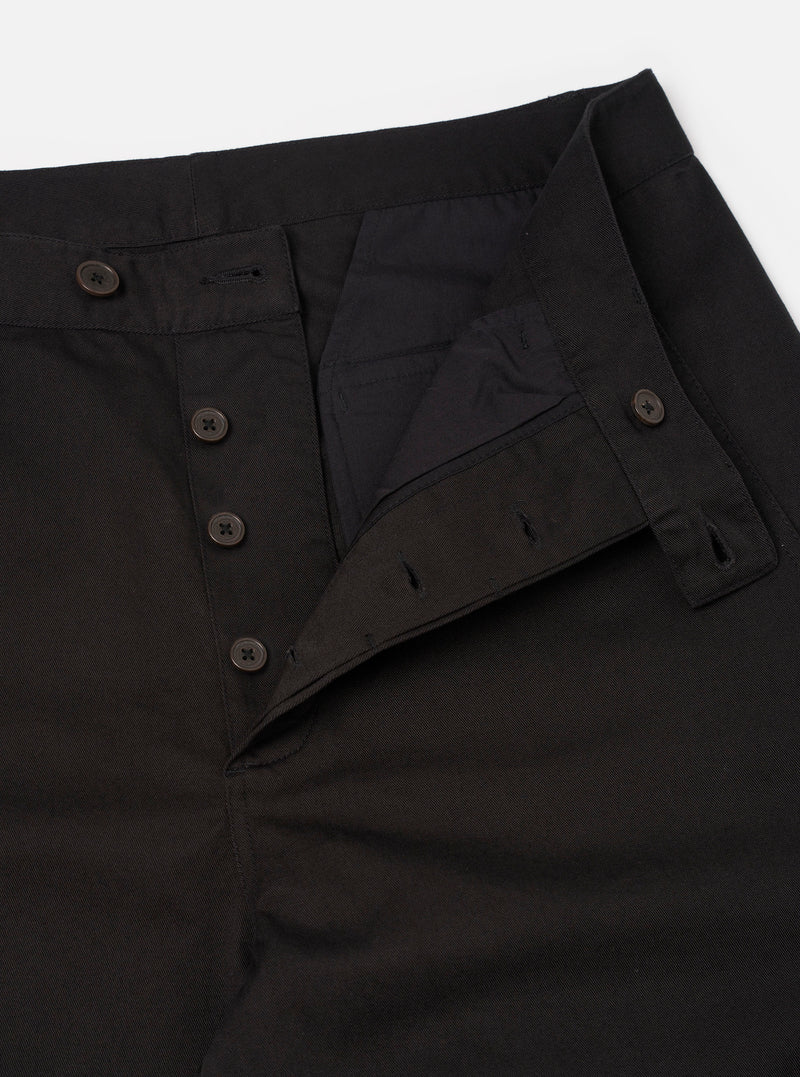 Detailed side angle shot of the Black Twill Curved Pant on a neutral white background. Highlights the unique angular side seam structure that gives these black twill trousers their signature wide, curved leg shape and volume.