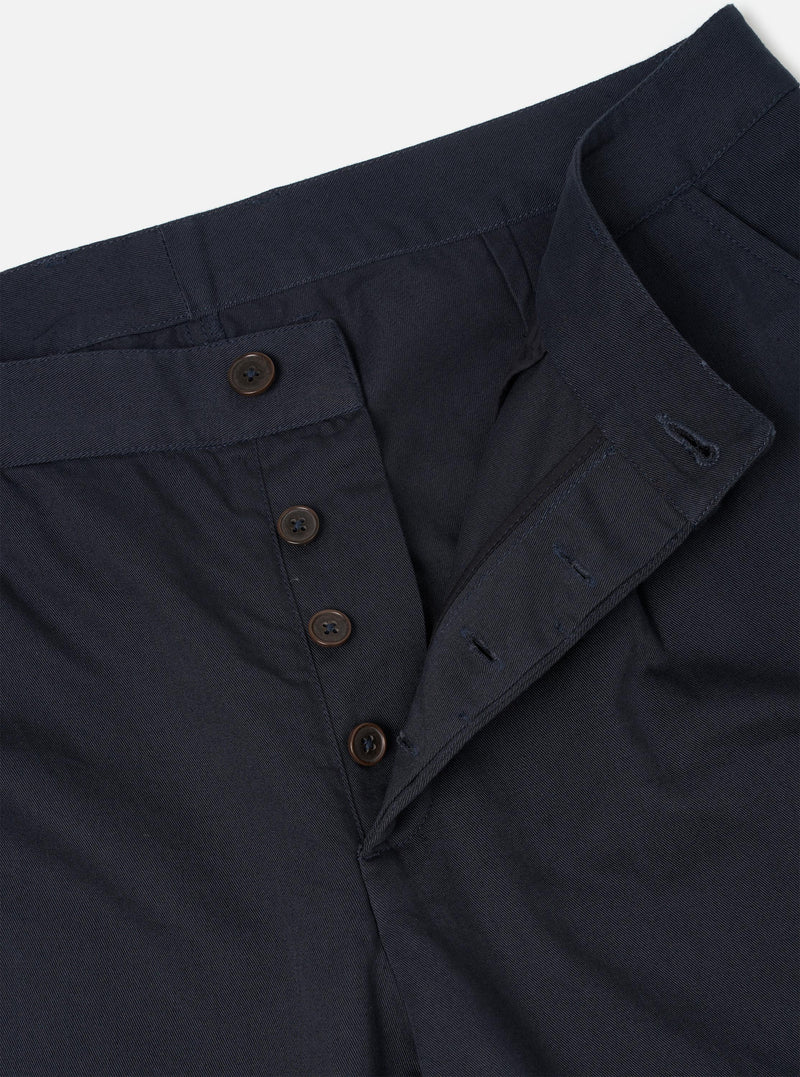 Detailed close-up shot of the Navy Twill Duke Pant shown on a neutral backdrop. Focuses on the fine cotton twill texture, single pleated front construction, clean seam stitching, and internal pocket details.