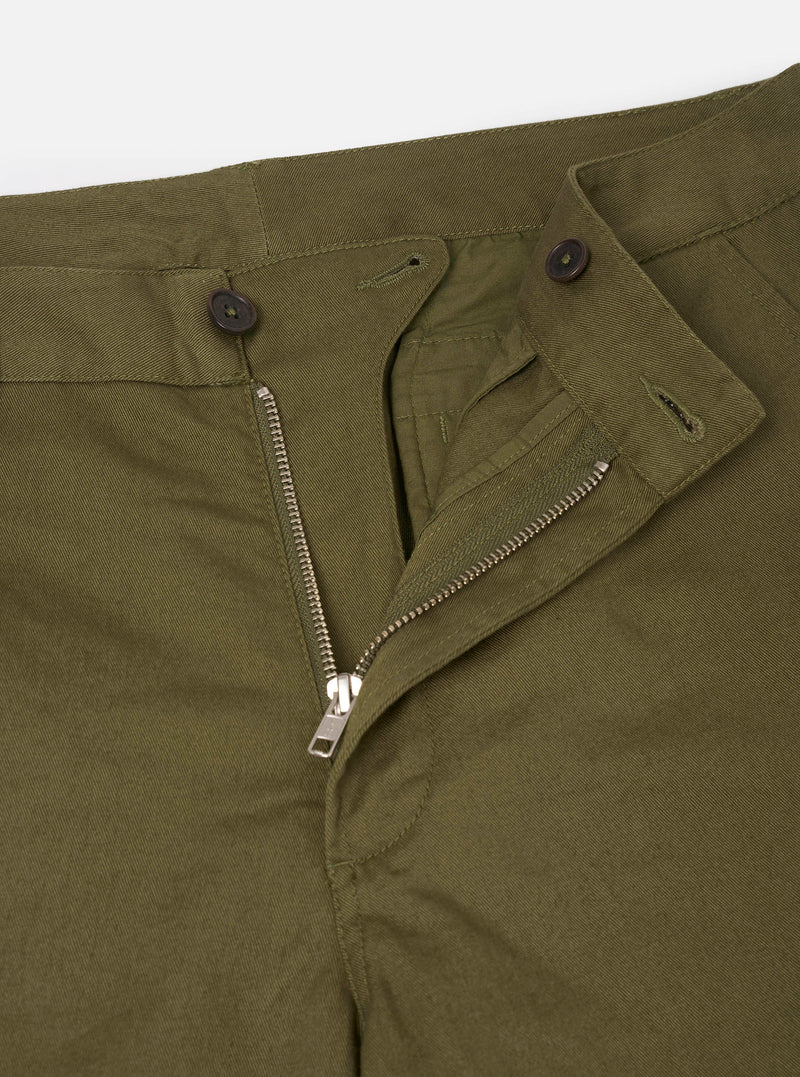 Close-up detail view of the Light Olive Twill Aston Pant set against a plain white background. Focuses on the waist construction, zip fly closure, refined stitching, and the textured 3/1 cotton twill weave in a light olive green shade.