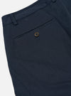 Close-up of the Navy Twill Aston Pant showing the back pocket with button closure. The twill fabric is visible against a white background.