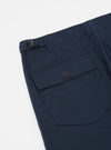 Close-up of the Navy Twill Fatigue Pant on a white background. Shows the twill fabric, buttoned pocket, and adjustable waist buckle.