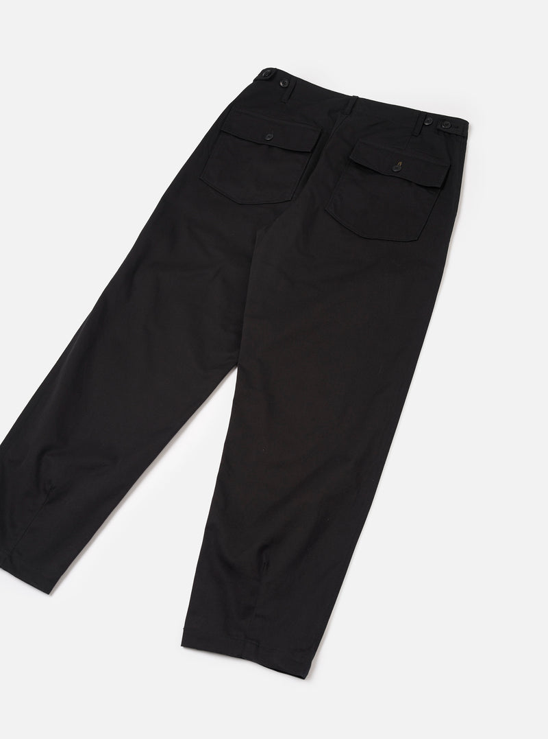 Rear view of the Black Twill Fatigue Pant laid flat against a bright white background. Features two buttoned rear flap patch pockets, neat central seam construction, straight relaxed leg shape, and solid black twill cotton material.