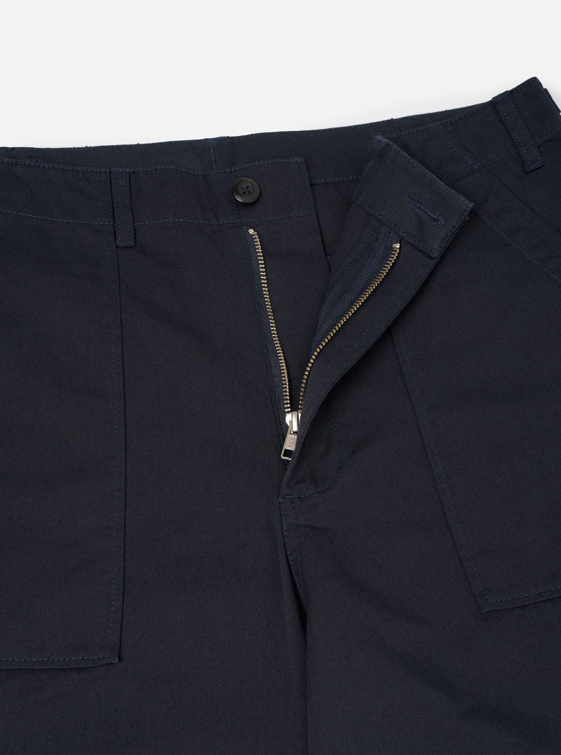 Detailed close-up shot of the Navy Twill Fatigue Pant against a plain studio background. Highlights the refined twill weave, sturdy waistband, front pocket stitching, and button fastener detail.