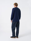 Side profile view of a model wearing the Navy Twill Fatigue Pant against a neutral background. Highlights the straight leg line, side seam construction, and structured fit around the hips and legs.