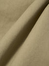 Close-up of the Sand Twill Fatigue Pant fabric. The material is a light tan color with a visible twill weave. The fabric is draped to show texture.