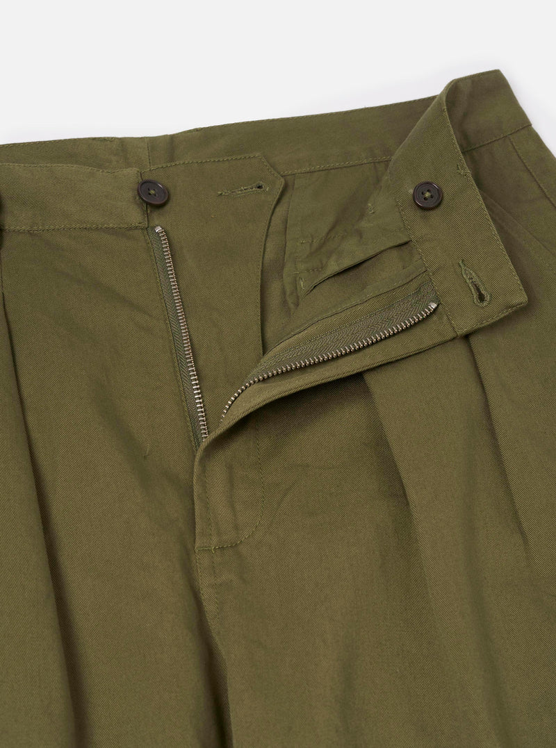 Close-up detail shot of the Light Olive Twill Double Pleat Pant against a plain background. Focuses on the double waist pleats, durable waistband stitching, top button, and subtle twill fabric texture.