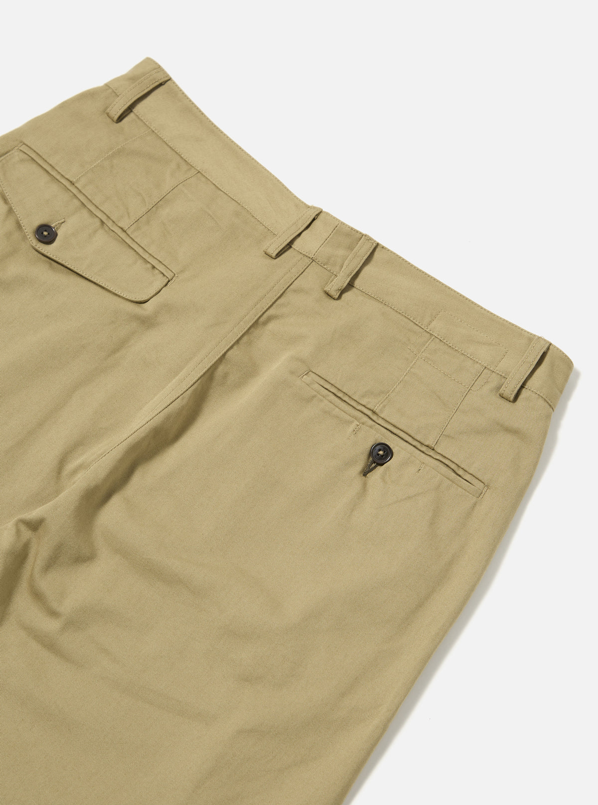 Close-up of the Sand Twill Double Pleat Pant on a white background, showcasing the twill fabric, double pleats, pockets, and button details.