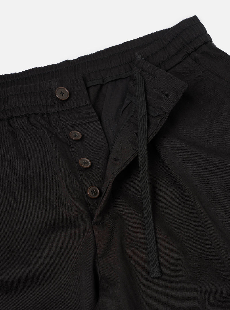 Close-up detail shot of the Black Twill Pleated Track Pant on a plain studio background. Focuses on the adjustable drawstring waist, waistband pleats, fine twill weave, and durable pocket stitching.