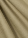 Close-up of the sand twill pleated track pant fabric. The material is a light tan color with a subtle ribbed texture. The fabric is draped to show its soft, flowing quality.