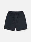 The Navy Twill Beach Short is displayed as a flat lay against a plain white background. The shorts feature an elasticated waistband with an external drawstring, two side pockets, and a single rear patch pocket on the right side. The navy blue cotton twill fabric shows a distinct diagonal weave.