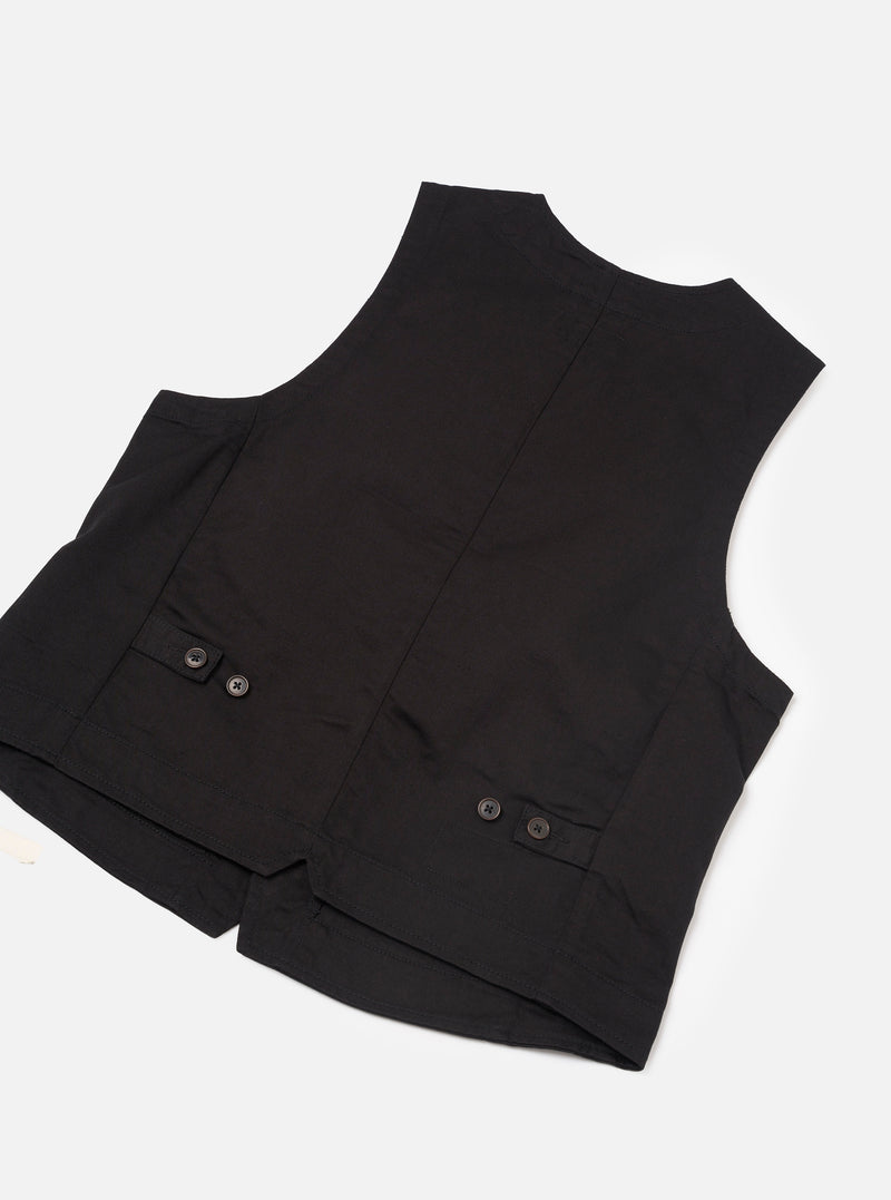 A close-up image of the Black Twill Field Waistcoat on a plain background. The shot details the metallic front zip zipper, precise stitching along the V-neck opening, and the textured black cotton twill fabric.