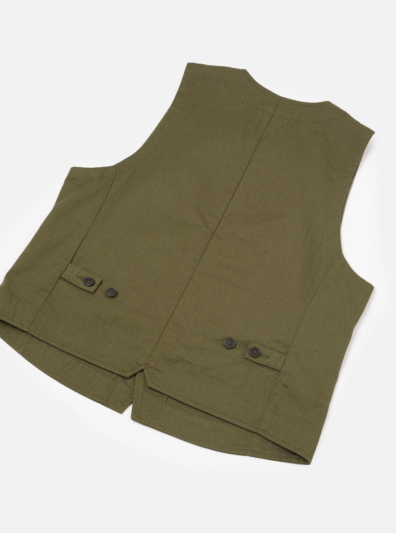 Close-up detailed view of the Light Olive Twill Field Waistcoat set against a plain white background. The image highlights the fine weave of the light olive twill fabric, sturdy stitching details around the front pockets, and button fastenings.