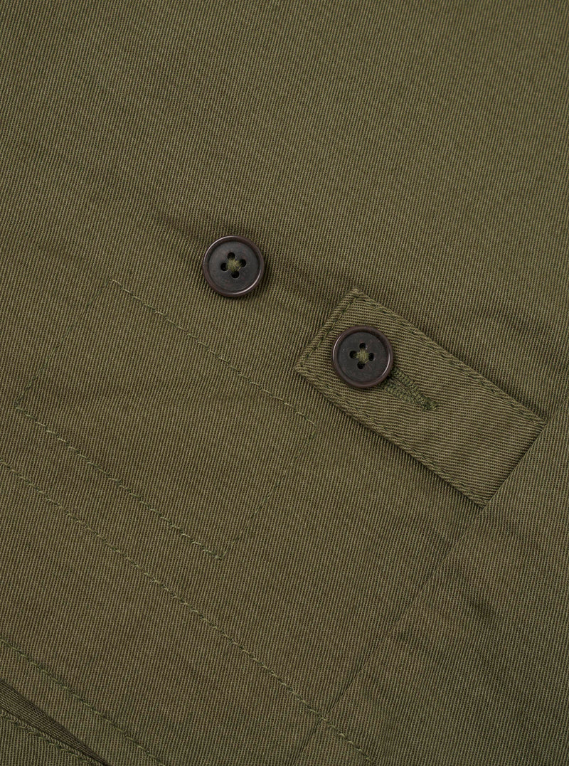 Detailed view of the Light Olive Twill Field Waistcoat displayed against a neutral white background. The image focuses on the interior lining details, neck label branding, fine twill weave, and durable button closures on the front panel.