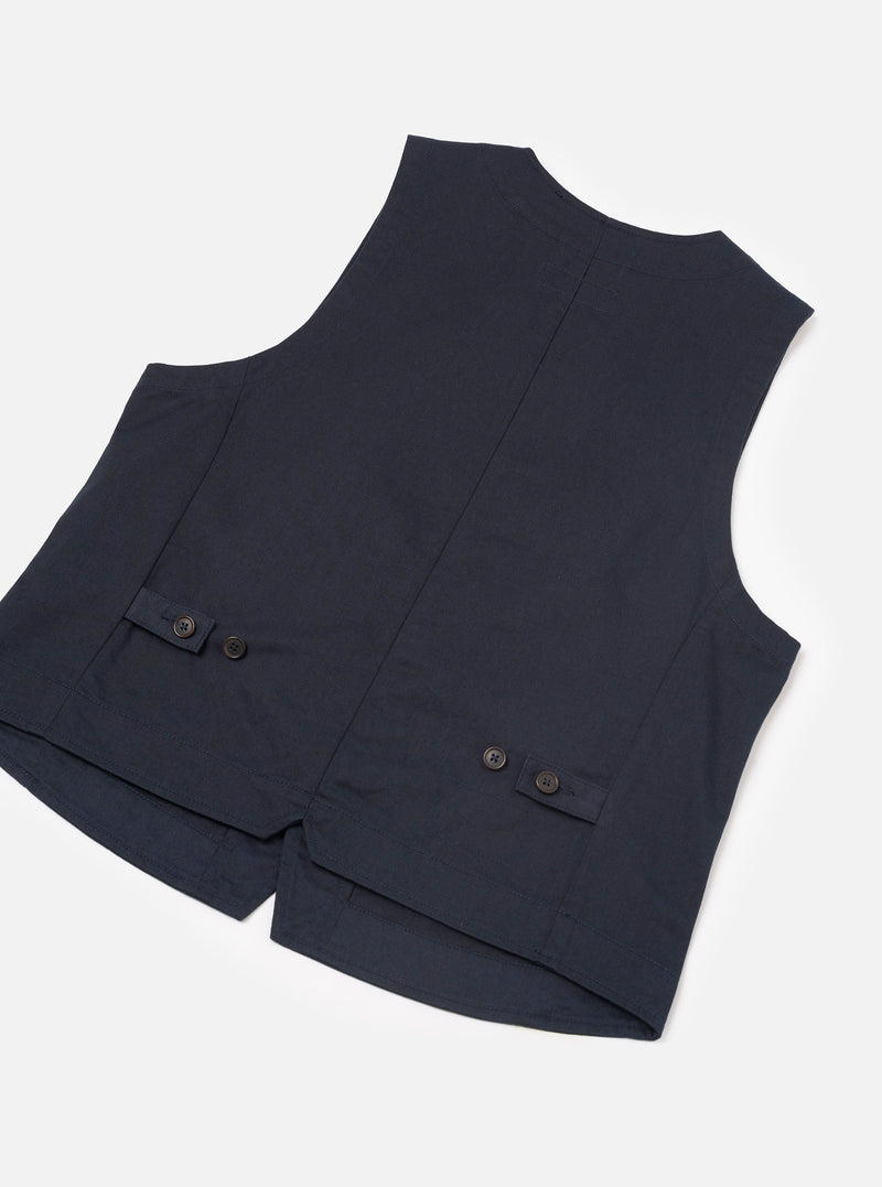 Close-up detail shot of the Navy Twill Field Waistcoat on a plain background. The image highlights the dark navy twill cotton fabric texture, secure front button construction, neat reinforced stitching, and prominent lower patch pocket edge.