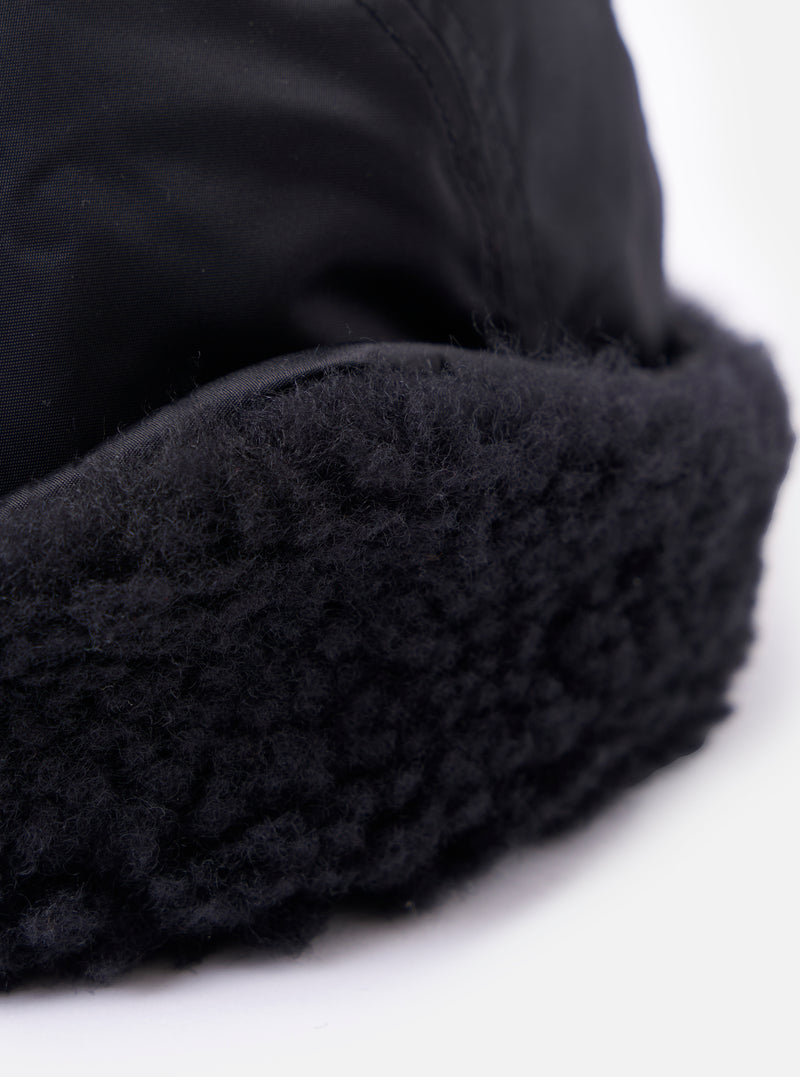 Close-up of the cableami® Black Military Nylon Twill Cap, showcasing the black nylon twill and plush black trim against a bright white background.