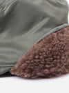 Close-up of the cableami® Olive Military Nylon Twill Cap. Shows the olive nylon twill and brown faux fur ear flaps. Shot on a white background.