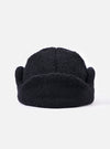 Close-up of the cableami® Black Recycled Wool Flight Watch Cap on a white background. The cap is made of black, textured wool and has a rounded shape.