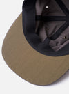 The cableami Grey/Olive Cotton/Nylon B.B Cap is shown from a rear angle as a flat lay against a plain white background. The image highlights the cap's six-panel construction and the elasticated band at the back designed for comfort. The olive green and grey fabric has a smooth, technical appearance.