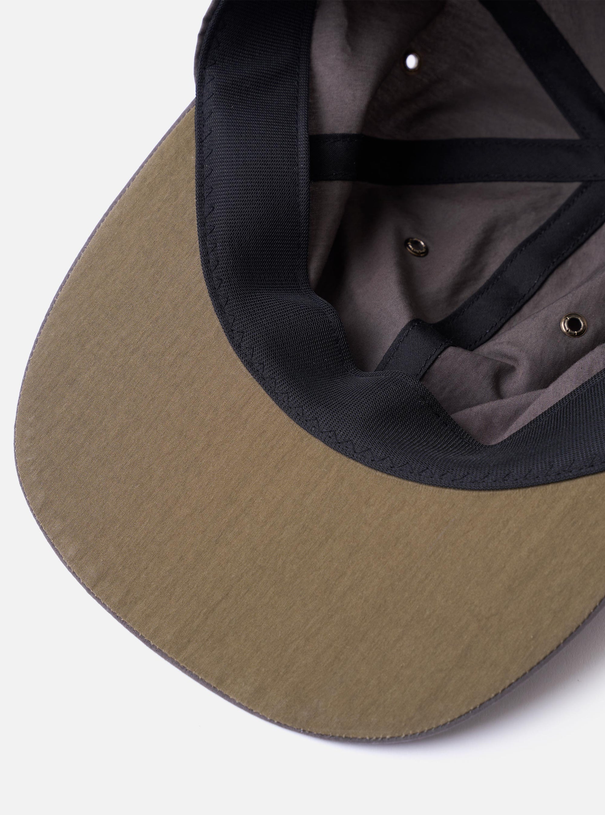 The cableami Grey/Olive Cotton/Nylon B.B Cap is shown from a rear angle as a flat lay against a plain white background. The image highlights the cap's six-panel construction and the elasticated band at the back designed for comfort. The olive green and grey fabric has a smooth, technical appearance.