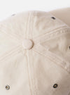 The cableami® Ivory/Olive Cotton/Nylon B.B Cap is shown from the back as a flat lay against a plain white background. The image highlights the rear of the six-panel crown and the elasticated band designed for a flexible fit. The cap features an ivory body with a contrasting olive brim and top button.