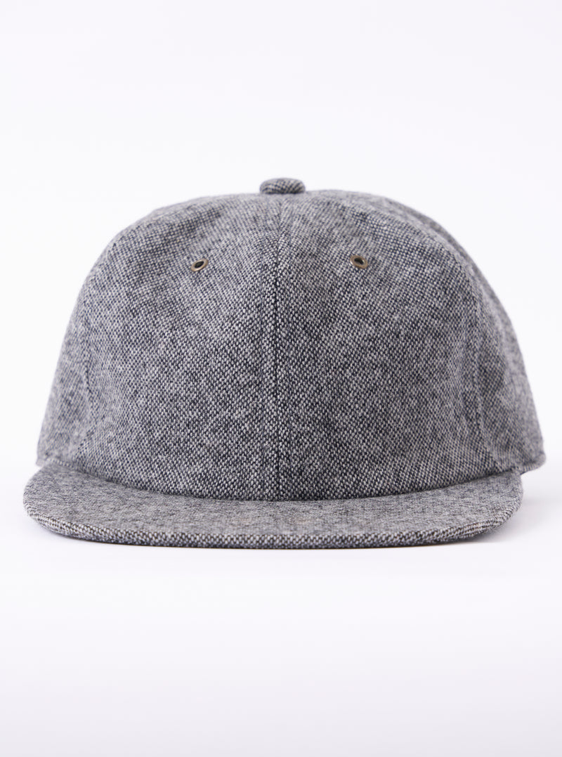 cableami® Black/White Recycled Tweed Cap on a white background. The cap is made of black and white tweed and has a classic fit.