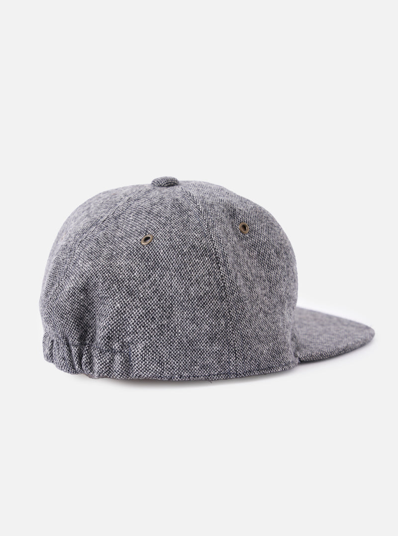 Back view of a cableami® Black/White Recycled Tweed Cap on a white background. The cap is made of black and white tweed and has a classic fit.