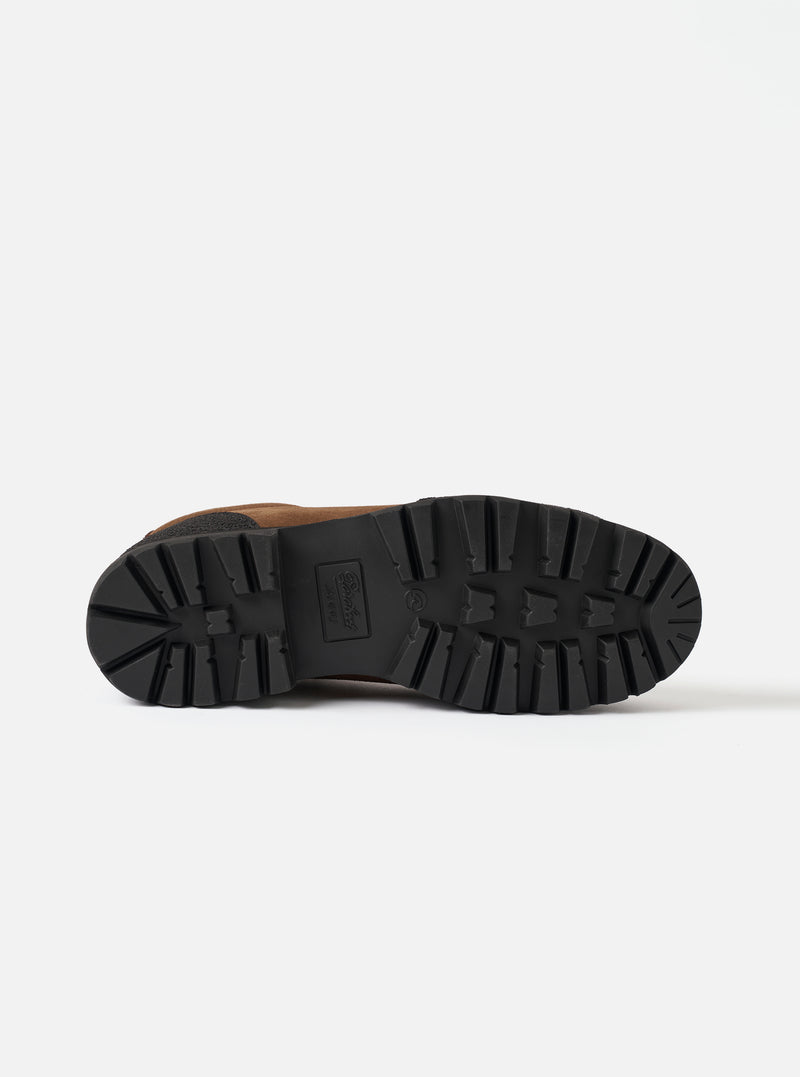The underside of the Paraboot Vel Marron Suede Montana/Jannu is shot against a plain light grey background. Features a black rubber lug sole with deep directional tread pattern, embossed center branding, and visible tan suede upper edges.
