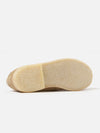 Close-up of the sole of a Sanders for Universal Works Milkshake Suede Edwin Loafer on a white background. The sole is a light tan color and made of a textured material.
