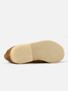 Close-up of the sole of a Sanders for Universal Works Tobacco Suede Edwin Loafer on a white background. The sole is a light tan color with a textured surface.