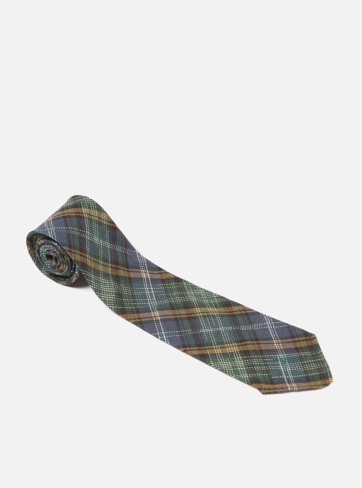 The Green Ikat Twill Check Tie is displayed on a white background. The tie features a green, blue, and brown plaid pattern.