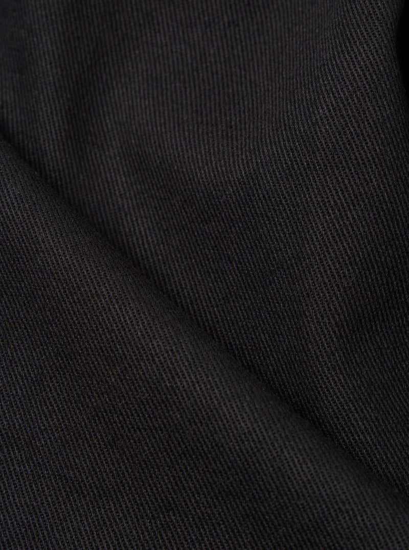 Close-up of the Black Twill Kyoto Work Jacket, showcasing the texture and material. The image highlights the jacket's durable twill fabric in a dark, solid color.