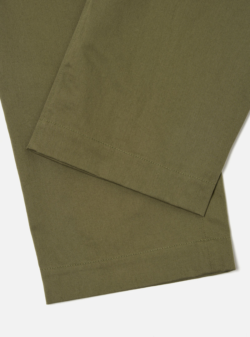 Close-up of the light olive Twill Duke Pant on a white surface. The twill fabric is visible, showcasing the texture and color of the pants.