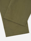 Close-up of the light olive Twill Duke Pant on a white surface. The twill fabric is visible, showcasing the texture and color of the pants.