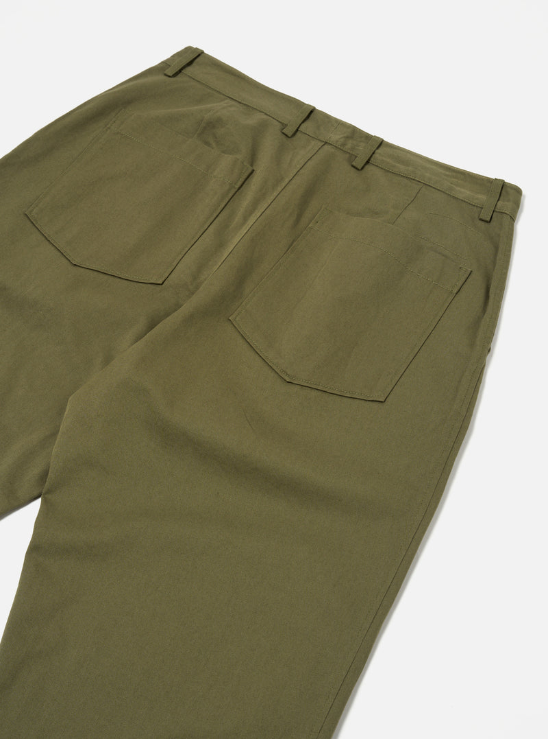 Close-up of the back of light olive twill Duke Pant on a white surface. The pants have a relaxed fit and visible back pockets.