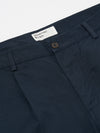 Close-up of the Navy Twill Duke Pant on a white background. The twill fabric is a deep navy, and the fit looks comfortable. Features a button closure and Universal Works label.
