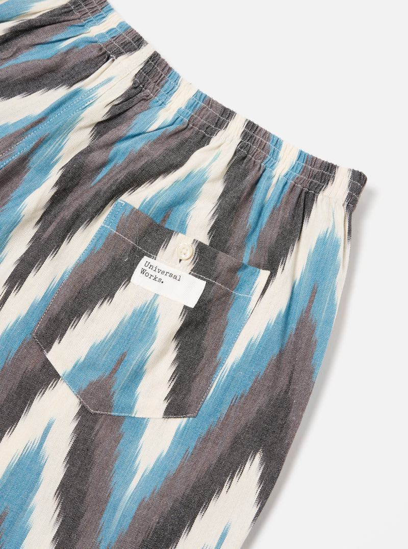 Close-up of Ecru Ikat II Cotton Boxer Short on a white background. Features blue, grey, and white ikat pattern, elastic waistband, and back pocket with button.