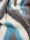 Close-up of the Ecru Ikat II Cotton Boxer Short fabric. Features a blue, white, and gray ikat pattern. Soft cotton material. Shot on a flat surface.