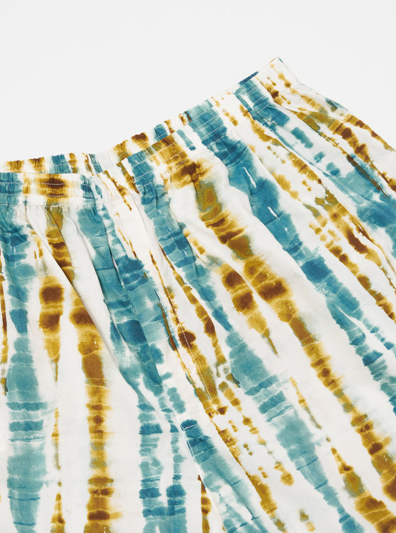 Close-up of the Ecru Paint Print Boxer Short on a white surface. The shorts feature a blue and brown tie-dye pattern with an elastic waistband.
