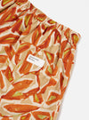 Close-up of Terracotta Artist Flower Lincot Boxer Short on a white surface. The shorts have a terracotta, beige, and green floral print, an elastic waist, and a back pocket with a 'Universal Works' tag.