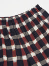 Close-up of the Navy/Brown Check Ikat Boxer Short on a white background. The shorts feature a navy, brown, and white check pattern with an elastic waistband.