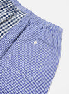 Close-up of the Blue Gingham Mix Pyjama Short on a white surface. Features a mix of blue gingham patterns and an elastic waistband.