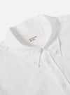 Close-up of the White Oxford Daybrook Shirt on a white surface. The crisp white cotton and button-down collar are visible.
