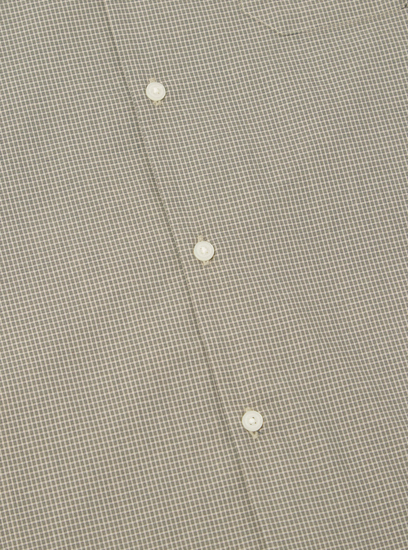 Close-up of the Green Tiny Check Long Pyjama Set, showing the fabric's small check pattern and white buttons. The background is a plain surface.
