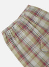 Close-up of the Green Kip Check Long Pyjama Set bottoms. The fabric is a soft green, red, and white plaid. Elastic waist. Shot on a white background.