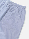 Close-up of the Navy Classic Stripe Short Pyjama Set. Blue and white striped shorts with an elastic waist and pocket, laid on a white surface.
