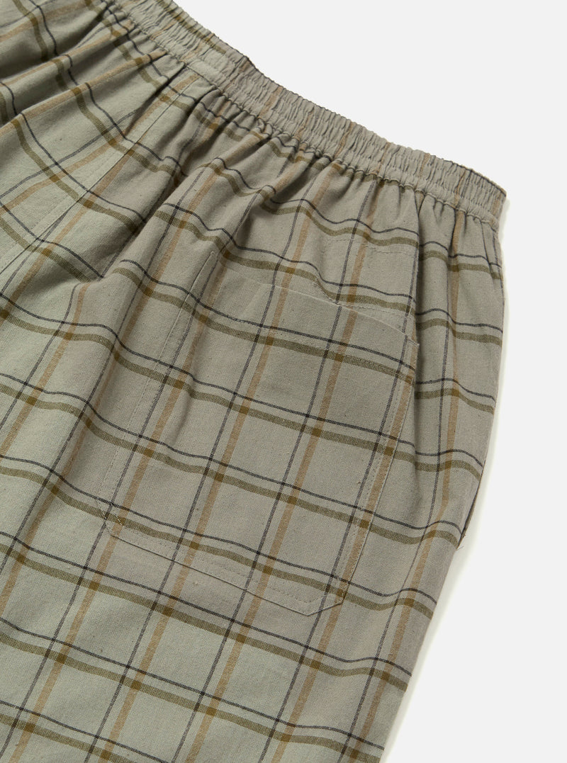 Close-up of the Green PJ Plaid Pyjama Short. The fabric is a soft, neutral plaid with brown and black lines. Elastic waistband and pocket are visible against a white background.